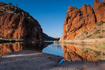 Reflections of rock formations at Glen Helen Gorge water hole