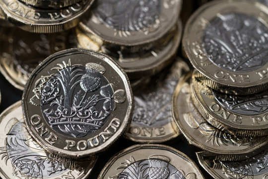 stack of new pound coins introduced in Britain in 2017, front and back