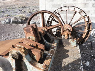 Rusty historic water pump in the dessert for agricultural means.