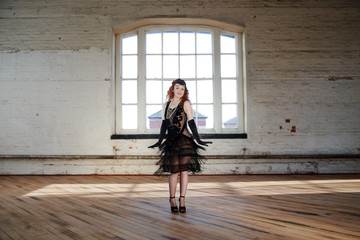 Beautiful Flapper dancer with black bugle bead see through dress, head dress and long red hair; dancing