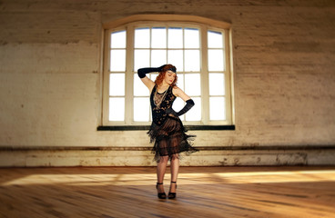 Beautiful Flapper dancer with black bugle bead see through dress, head dress and long red hair;...