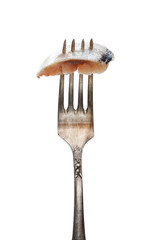 sliced  salted herring on vintage fork