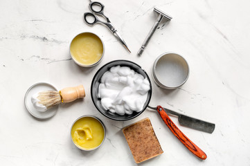 Tools for cutting beard in barbershop on workplace background top view