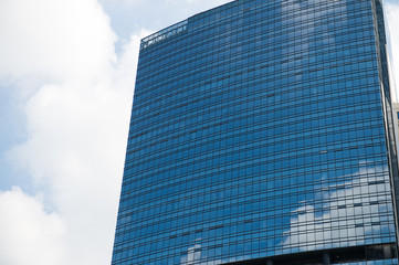 Fototapeta premium Sky and clouds reflected in windows of modern office building.