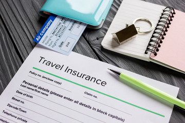 Travel insurance application form on wooden desk background