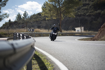  Motorcyclist taking a bend in a mountain pass