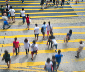 Busy city people on zebra crossing street in Hong Kong, China.