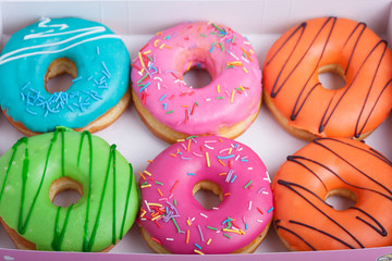 Colored donuts with glaze in a box