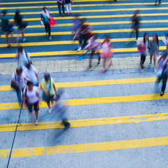 Busy city people on zebra crossing street in Hong Kong, China.