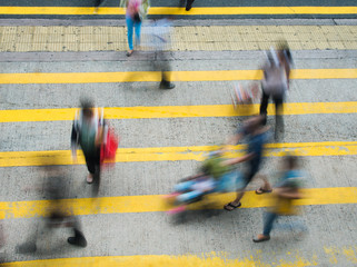 Busy city people on zebra crossing street in Hong Kong, China.