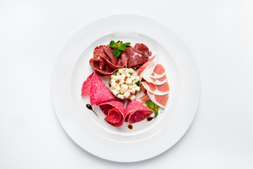 Dish of various types of meat-cutting on plate.