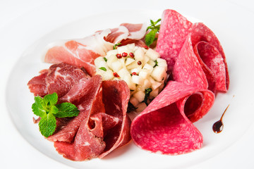 Dish of various types of meat-cutting on plate.