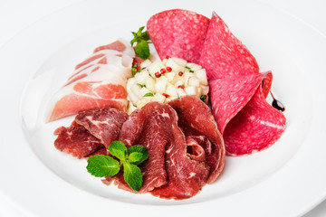 Dish of various types of meat-cutting on plate.