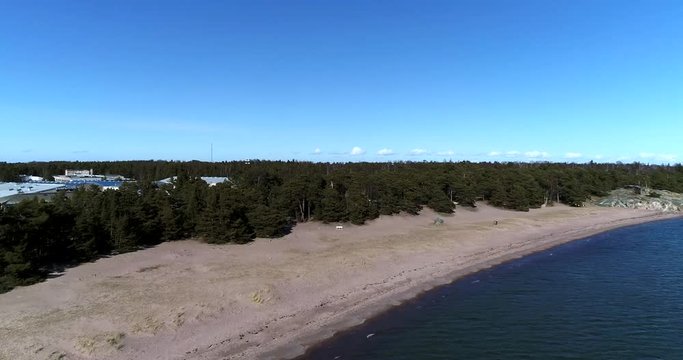 Hanko tulliniemi beach, Cinema 4k aerial flight towards the beach at tulliniemen ranta, on a sunny spring day, in Hango, Finland