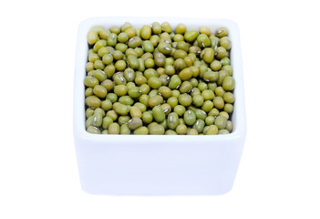 Ceramic bowl with mung beans on white background