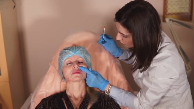 The cosmetician doctor checks how the fillers has resolved. Special cannula movements allow to put under a skin a hyaluronic acid-based product.
