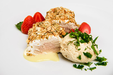 Meat covered in crumpet of pumpkin seeds served on plate.