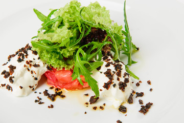 Vegetable salad with white sauce and grilled crumbs on plate.