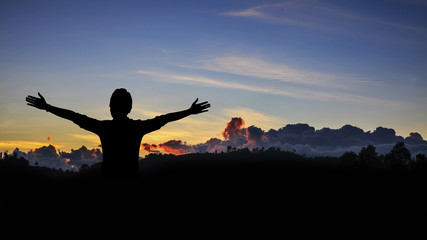 Woman relaxing in sunset sky.Freedom and natural concept.