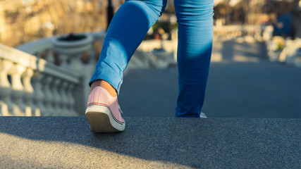 Young girl is walking downstairs on ladder.