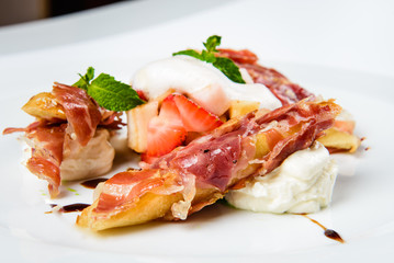 Baguette pieces covered with grilled bacon on plate served luxury.