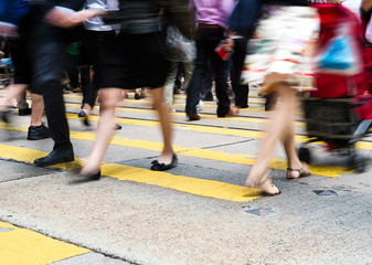 Busy city people on zebra crossing street in Hong Kong, China.