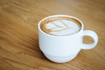 Cup of coffee on wood background