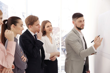 Business trainer giving presentation to group of people © Africa Studio