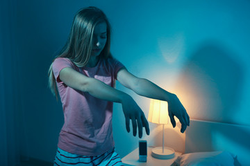 Young sleepy woman suffering from somnambulism at home