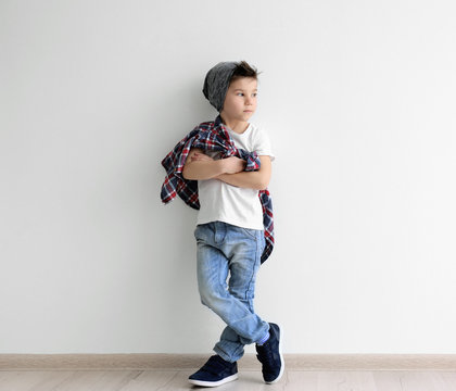 Cute stylish boy near light wall Stock Photo | Adobe Stock Cute stylish boy near light wall Stock Photo | Adobe Stock