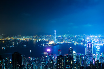 Fototapeta na wymiar Hong Kong cityscape at night with victoria harbour and large group of tall buildings.