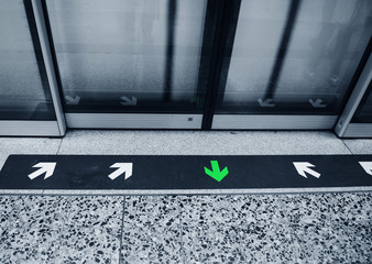 subway door with arrow for in and out.