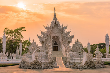 Wat Rong Khun()at sunset in Chiang Rai,Thailand.03/04/2017 Wat Rong Khun is modern building, well known worldwide.It was  designed by  Chalermchai Kositpipat.