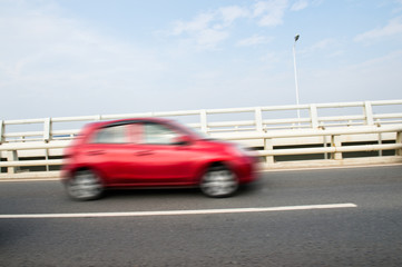 Blurred car speeding on the highway