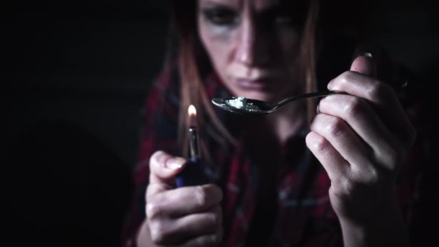 4k Homeless Drugged Woman Burning a Spoon with Drugs
