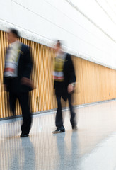 Business people rushing in the lobby. motion blur