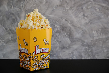 Popcorn on the table with grey background 