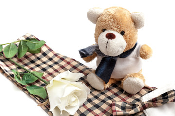 White rose and bear doll put on the chess style fabric