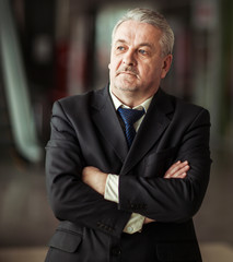portrait of a successful businessman on background of modern office