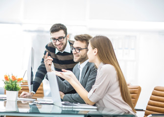 Fototapeta premium professional business team is developing a new project ,sitting behind a Desk in a modern office.
