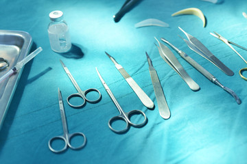 Surgical instruments, silicone nasal implant and silicone chin implants in operating room.