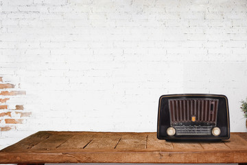 Vintage radio on wood table with copy space in white room.