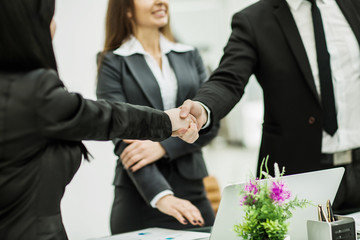 handshake successful business partners in the workplace in the o