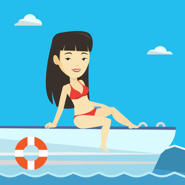 Young happy woman tanning on sailboat.