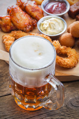 Mug with beer on the background of beer snack