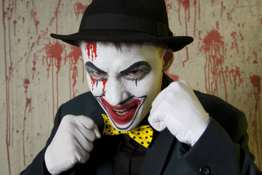 Evil clown boxer wearing a bowler hat on wall