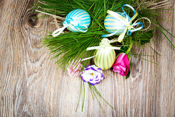 Easter eggs with flowers on wooden background. Toned image