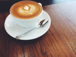 Hot coffee with cup on old wood background.