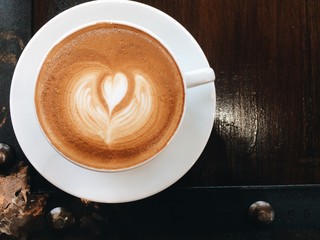 Hot coffee with cup on old wood background.