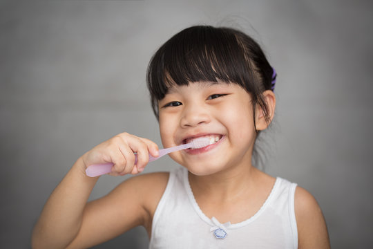 Little Asian Cute Girl Brush Teeth